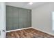 Bright bedroom with wood-look floors and an accent wall at 4756 Acorn Dr, Mulberry, FL 33860