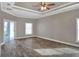 Main bedroom with ceiling fan and wood-look tile floors at 4756 Acorn Dr, Mulberry, FL 33860
