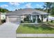 One-story home with a large front yard, attached garage, and attractive landscaping at 4756 Acorn Dr, Mulberry, FL 33860