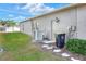 Rear exterior view showing AC unit, storage area, and landscaping at 4756 Acorn Dr, Mulberry, FL 33860