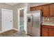 Kitchen with stainless steel refrigerator and pantry access at 4756 Acorn Dr, Mulberry, FL 33860