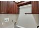 Laundry room with wood cabinets and hanging rod at 4756 Acorn Dr, Mulberry, FL 33860