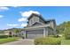 Two-story home with gray exterior, two-car garage, and manicured landscaping at 6857 Eagle Ridge Loop, Lakeland, FL 33813