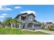 Two-story house with gray exterior, two-car garage, and landscaping at 6857 Eagle Ridge Loop, Lakeland, FL 33813