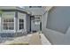 Inviting entrance with a gray door and landscaping at 6857 Eagle Ridge Loop, Lakeland, FL 33813