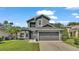 Two-story house with gray exterior, two-car garage, and landscaping at 6857 Eagle Ridge Loop, Lakeland, FL 33813