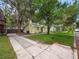 Yellow house with a long driveway and lush green lawn at 714 Winfree Ave, Lakeland, FL 33801