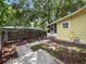 Backyard of the property with a side patio and privacy fence at 714 Winfree Ave, Lakeland, FL 33801