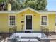 Front view of a charming yellow house with a black door at 714 Winfree Ave, Lakeland, FL 33801
