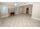 Bright living room with tile floors, fireplace, and view into kitchen at 714 Winfree Ave, Lakeland, FL 33801