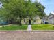 Cute yellow house with a brick walkway and a yard at 714 Winfree Ave, Lakeland, FL 33801