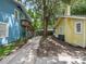 View of backyard, showing a shared driveway and landscaping at 714 Winfree Ave, Lakeland, FL 33801