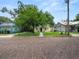 Yellow house on a brick street with a large tree and neighboring houses at 714 Winfree Ave, Lakeland, FL 33801