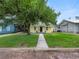 House with a walkway leading to the front door and a large tree in the front yard at 714 Winfree Ave, Lakeland, FL 33801
