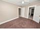 Bright bedroom with carpet flooring and access to a bathroom at 714 Winfree Ave, Lakeland, FL 33801