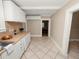 Galley kitchen with white cabinets and view to adjacent room at 714 Winfree Ave, Lakeland, FL 33801