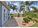 Spacious paver patio with seating area, lush landscaping, and pond views at 544 Narrow Pond Rd, Polk City, FL 33868