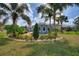 Charming house exterior with nicely landscaped yard and RV parking at 544 Narrow Pond Rd, Polk City, FL 33868