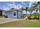 Guest house with gray exterior, paved patio, and lush landscaping at 544 Narrow Pond Rd, Polk City, FL 33868