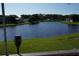 Scenic view of a lake from a backyard with green grass at 2147 Cypress Cross Dr, Lakeland, FL 33810