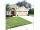 House exterior with red front door and two car garage at 1045 View Pointe Way, Lakeland, FL 33813