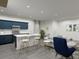 Open concept kitchen and living area with dark blue cabinets and gray flooring at 265 Crossings Ave, St Cloud, FL 34771