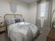 Cozy bedroom with a bed featuring a woven headboard and throw blanket at 265 Crossings Ave, St Cloud, FL 34771