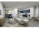 Open living room and kitchen with gray flooring and navy blue accents at 265 Crossings Ave, St Cloud, FL 34771