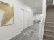 Bright hallway with gray wood-look floors, white walls, and a stylish rug at 265 Crossings Ave, St Cloud, FL 34771