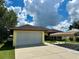 House exterior featuring a carport and two-car garage at 180 Lakeview Dr, Haines City, FL 33844