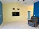 Living room with a mounted TV, neutral walls, and a comfy recliner at 180 Lakeview Dr, Haines City, FL 33844