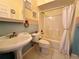 Bathroom with tub, shower, and pedestal sink at 180 Lakeview Dr, Haines City, FL 33844