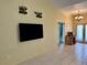 Living room with a large mounted TV and access to other rooms at 180 Lakeview Dr, Haines City, FL 33844