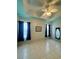 Spacious living room with tile floors, ceiling fan, and ample natural light at 180 Lakeview Dr, Haines City, FL 33844