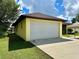 Single-car garage with white door and adjacent carport at 180 Lakeview Dr, Haines City, FL 33844