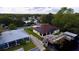 Aerial view of canal-front home with solar panels and private dock at 180 Lakeview Dr, Haines City, FL 33844