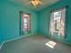 Bright bedroom with teal walls, ceiling fan and carpet at 180 Lakeview Dr, Haines City, FL 33844