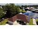 Aerial view showing home's canal-front location and solar panels at 180 Lakeview Dr, Haines City, FL 33844