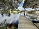 Covered boat lift with waterfront access at 180 Lakeview Dr, Haines City, FL 33844
