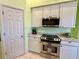 Bright kitchen with white cabinets, granite counters, and stainless steel appliances at 180 Lakeview Dr, Haines City, FL 33844