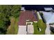 Aerial view of the house showing solar panels and a dock at 180 Lakeview Dr, Haines City, FL 33844