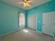 Bedroom with teal walls, ceiling fan, and carpet at 180 Lakeview Dr, Haines City, FL 33844
