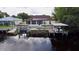 Aerial showcasing canal-front home, dock, and solar panels at 180 Lakeview Dr, Haines City, FL 33844