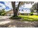 Ranch style home with metal roof, two car garage, and mature landscaping at 310 Willow Oak Ct, Fort Meade, FL 33841