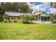 Single-story home with metal roof and a large backyard at 310 Willow Oak Ct, Fort Meade, FL 33841