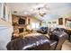 Relaxing living room with fireplace, leather furniture, and access to kitchen at 310 Willow Oak Ct, Fort Meade, FL 33841