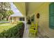 Side view of the porch with rocking chairs and landscaping at 310 Willow Oak Ct, Fort Meade, FL 33841