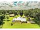 Aerial view of a house with a large backyard and surrounding trees at 310 Willow Oak Ct, Fort Meade, FL 33841