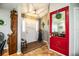 Inviting entryway with red door and wood flooring at 310 Willow Oak Ct, Fort Meade, FL 33841