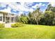 Large backyard with a screened patio and lush green lawn at 310 Willow Oak Ct, Fort Meade, FL 33841